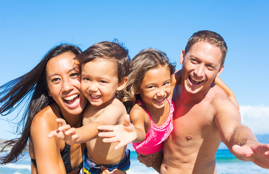 A family laughing together on an Australian beach